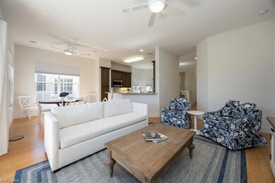 Living room featuring ceiling fan, hardwood / wood