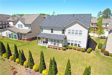 Back of house featuring a residential view, roof with shingles, and a lawn