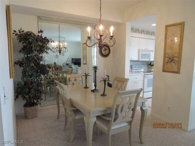 Dining space featuring a chandelier, light carpet,