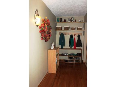 Entry. The entry with hardwood flooring and sconce lighting can also be used as the popular 