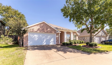 View of front of property featuring a front yard and a garage