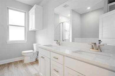 Bathroom featuring hardwood / wood-style floors, t
