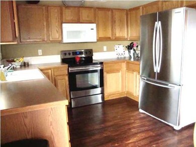 Kitchen has lots of cabinets and stainless steel r