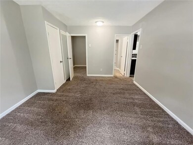Carpeted spare room with baseboards