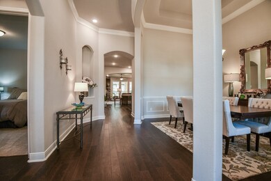 Another view of the entry. This home offers soaring ceilings and lovely real hardwood floors.