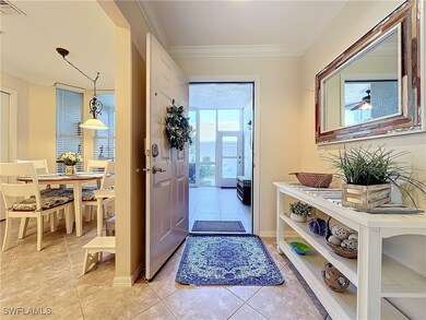 Doorway with crown molding and light tile patterne