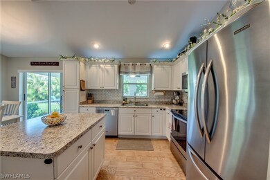 Tiled backsplash, newer appliances, plank tile floors, modern-highly functional kitchen