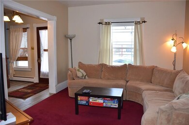 Formal living room has rosette trimmed windows & e