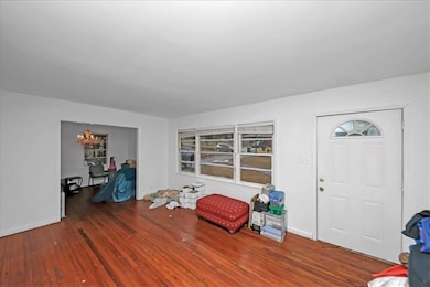 Entrance foyer featuring dark wood-style floors and a chandelier