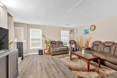 Living area with light wood finished floors and ba