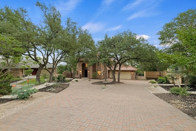 View of front of house with curved driveway, a fe