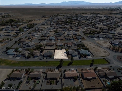 Aerial view of property's location featuring mountains and nearby suburban area
