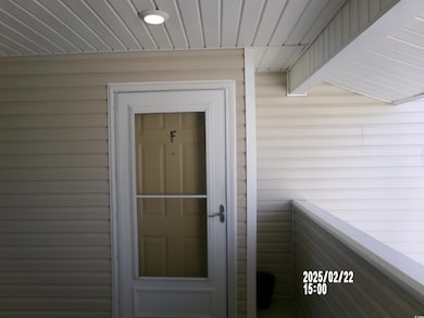 Property entrance with a balcony