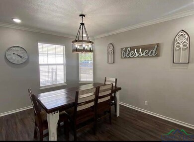 Dining space featuring baseboards, a textured ceil