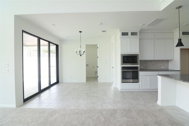 Kitchen with oven, a chandelier, built in microwa