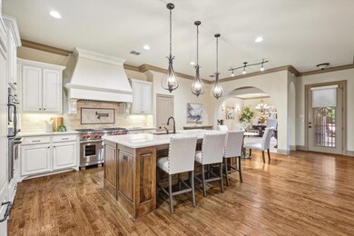Kitchen featuring dark wood-type flooring, custom 