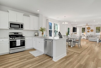 Kitchen featuring stainless steel appliances, whit