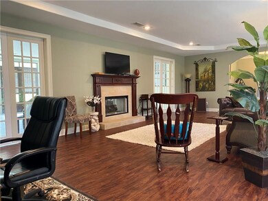 Living Room with Tray Ceiling and Double-Sided Fir