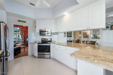 Kitchen with white cabinets, ceiling fan, light st