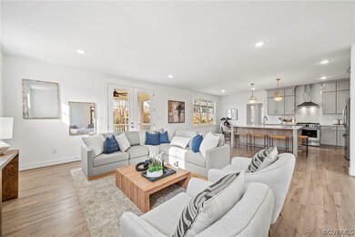 Living room with light hardwood / wood-style floor