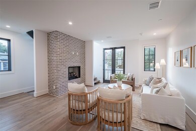 Living room with a fireplace and light wood-type f