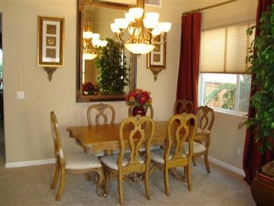Formal dining area with custom chandelier.