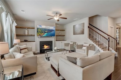 Living room featuring light hardwood / wood-style flooring and ceiling fan