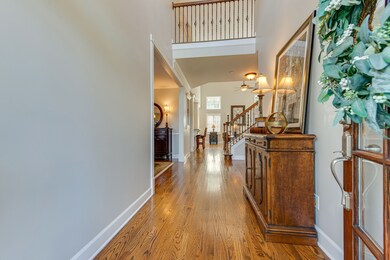 Entry foyer with glass panel front door, freshly pained with hardwood floors though-out the main level.