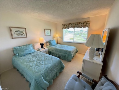 Bedroom with carpet flooring and a textured ceilin
