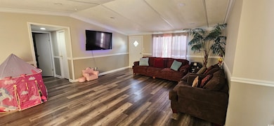 Living room featuring vaulted ceiling, dark hardwo