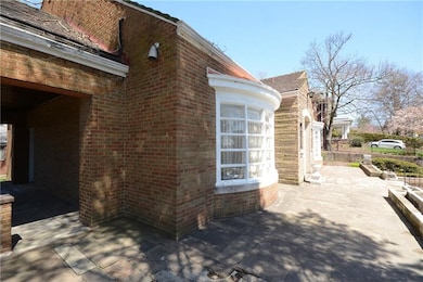 Large patio which wraps around leading to a brick 