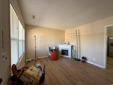 Unfurnished living room featuring a textured ceili