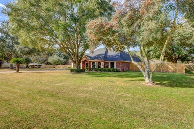 Nicely landscaped with beautiful trees all sitting on one acre.