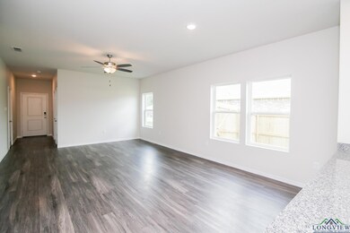 Unfurnished living room featuring a ceiling fan, dark wood-style flooring, baseboards, and recessed lighting
