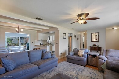 Living area with visible vents, baseboards, light