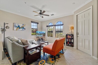 Tiled living room featuring ceiling fan, a firepla
