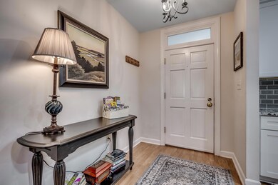 Entrance foyer with light hardwood / wood-style fl