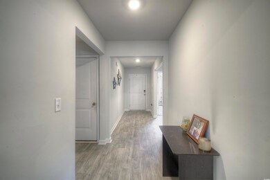 Hall featuring light wood-type flooring and baseboards