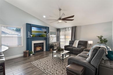 2122 Palm Crest Dr - family room with a cozy fireplace and sliders that look out to the pool