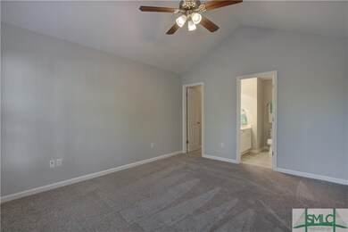 Master bedroom on main level with vaulted ceiling 