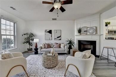 Living room featuring a fireplace, visible vents, 