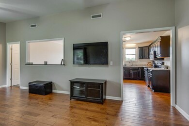 Another view of living area with opening to kitchen and dining.