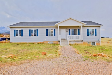 Single story home featuring a shingled roof, covered porch, and a front yard