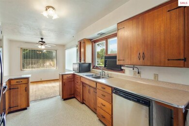 Roomy kitchen, retro wood cabinets, and breakfast 