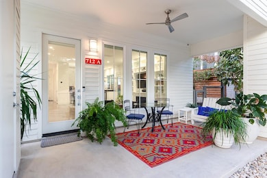 Welcoming front porch with ceiling fan overlooks fenced front yard