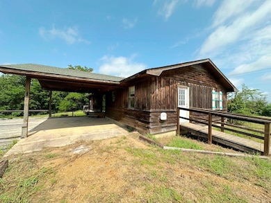 View of property exterior featuring an attached carport