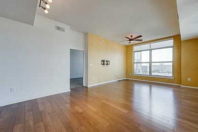 Spacious living room with windows overlooking park