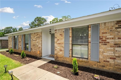 Property entrance featuring brick siding