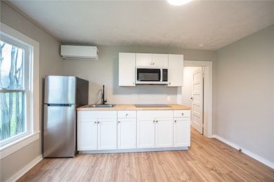 Kitchen featuring light wood-style flooring, a wal