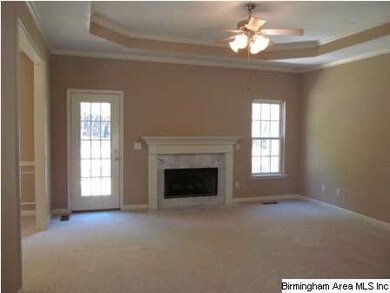 Cozy den with marble surround gaslog fireplace